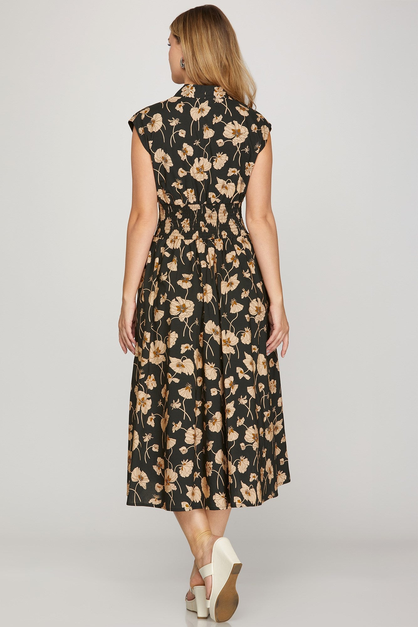 Back view of flowy floral zip-front midi dress with pockets