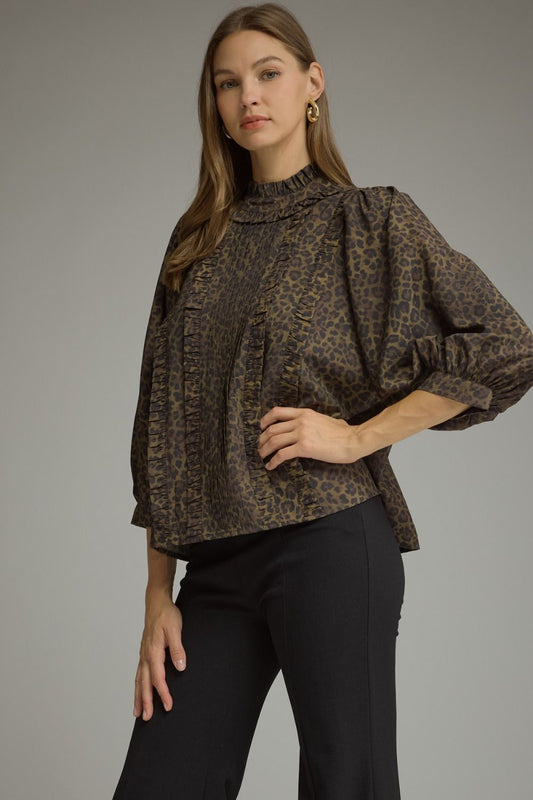 Entro-Animal print ¾ balloon sleeve top with a ruffle stand collar. Ruffle trim detail at front. Back keyhole with button closure. Gathered detail at back.
