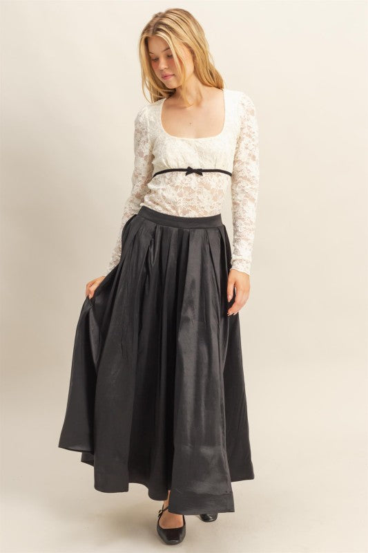 Model wearing pleated A-line midi skirt styled for day to night