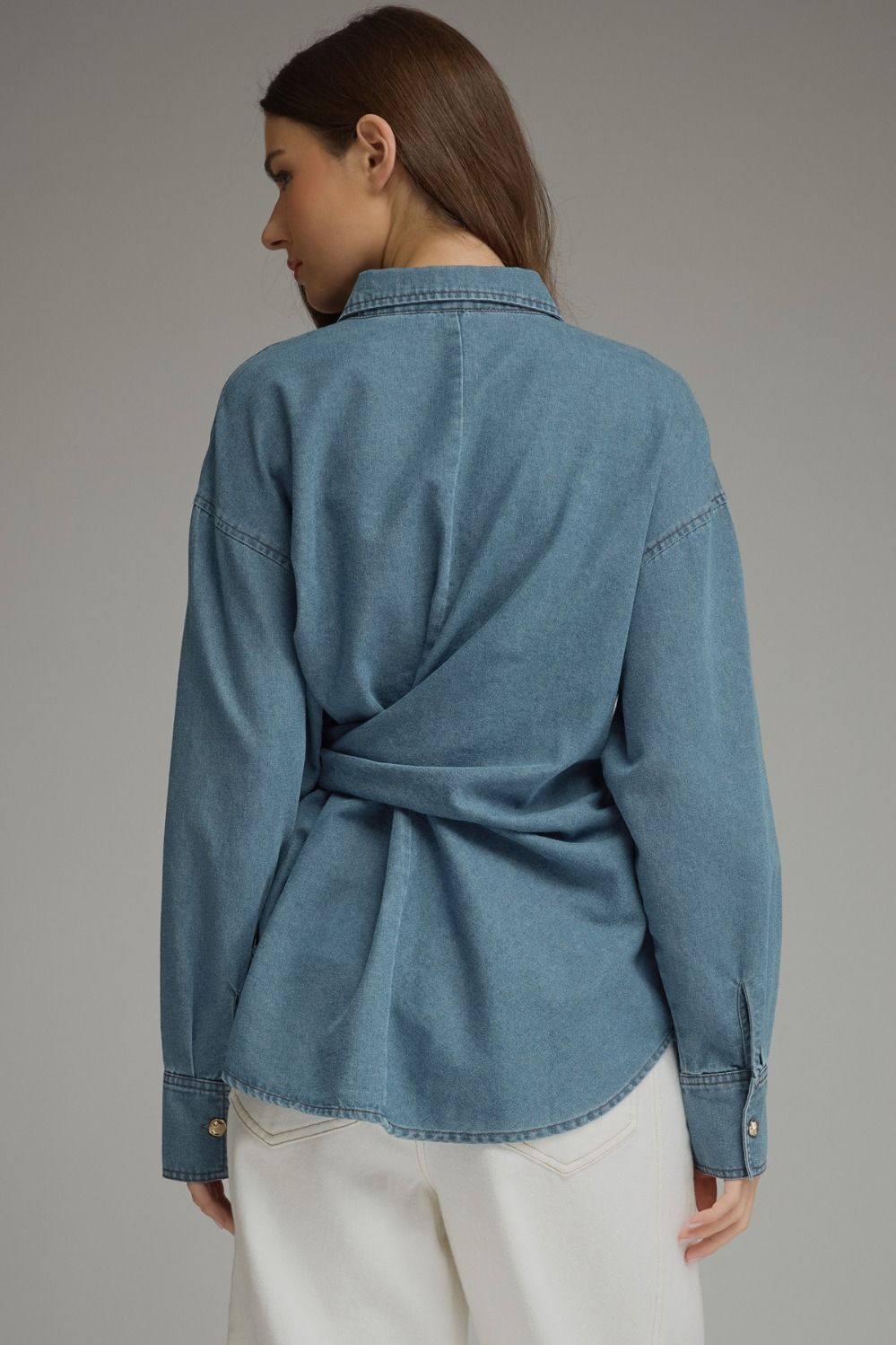 Entro-Solid denim long sleeve top featuring button closure at front and a wraparound self-tie detail. Button cuffs.