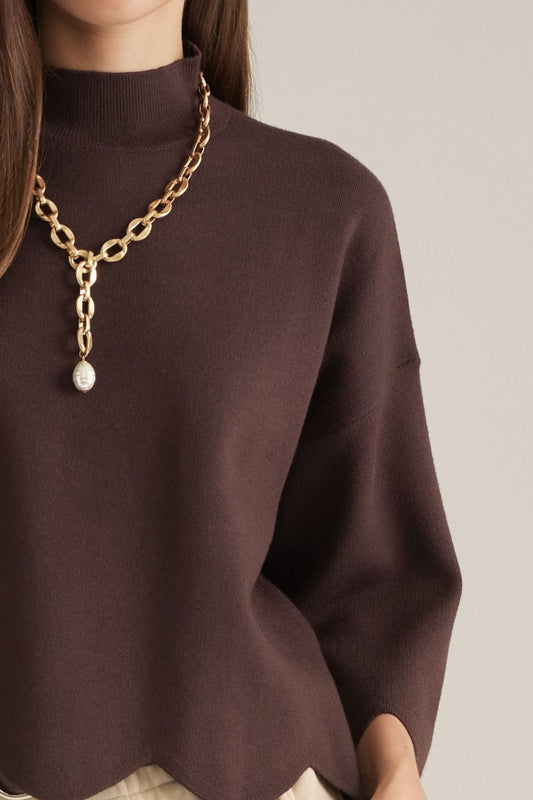 Entro-Solid ¾ sleeve sweater top with a mock neck. Scalloped hem and sleeve edges.