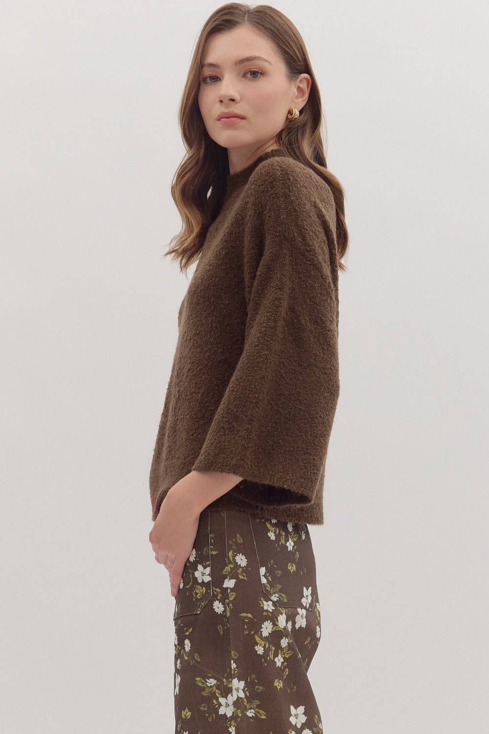 Side view of mock neck sweater top in neutral tone