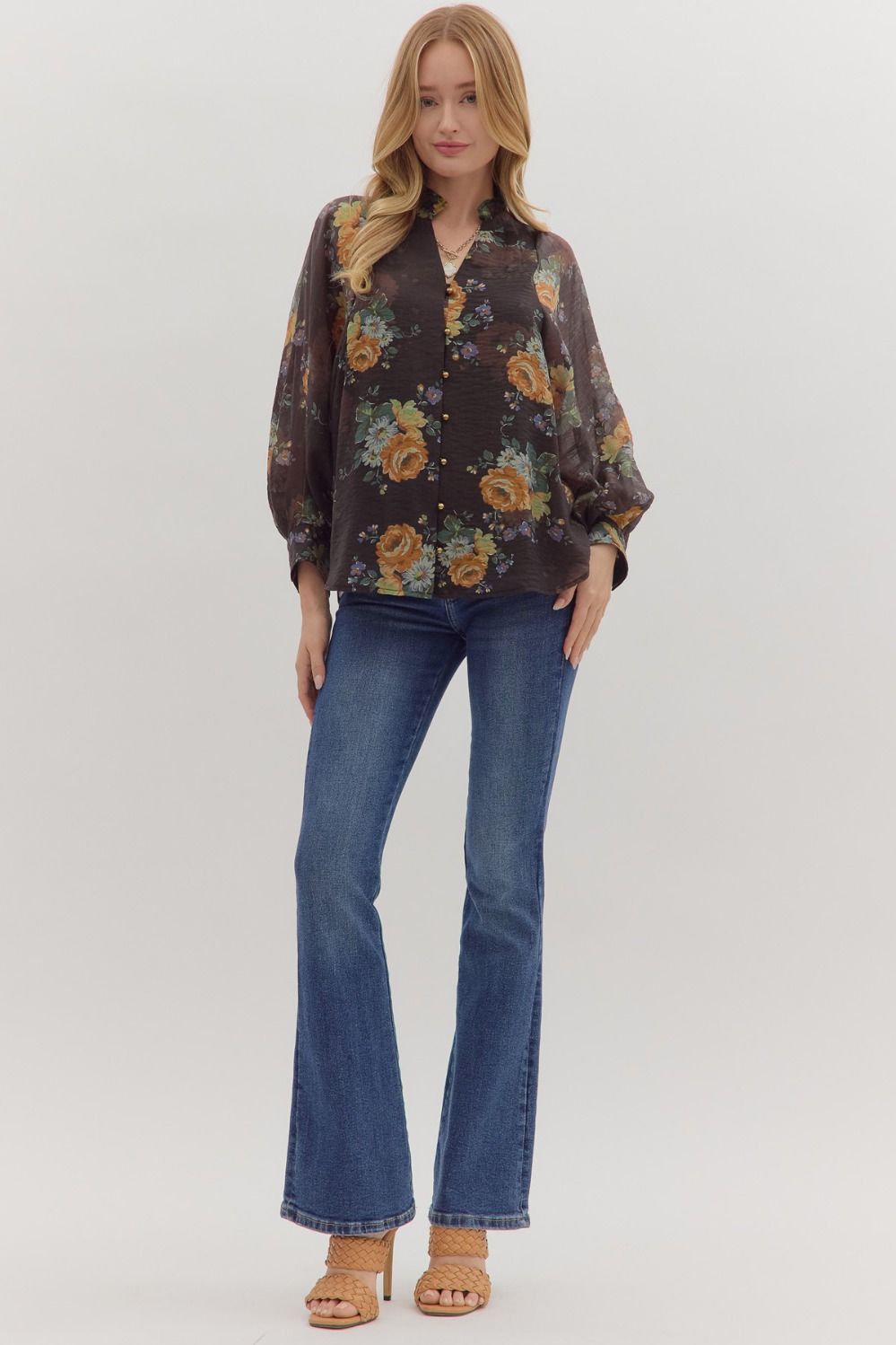 Feminine floral top styled with puff sleeves and button front