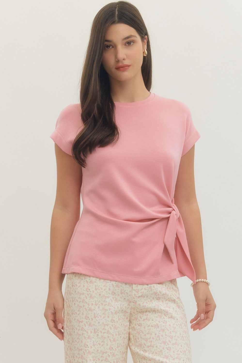 Entro Solid short-sleeve top featuring side self-tie bow detail at waist and round neck. Unlined. Knit. Non-sheer. Lightweight.