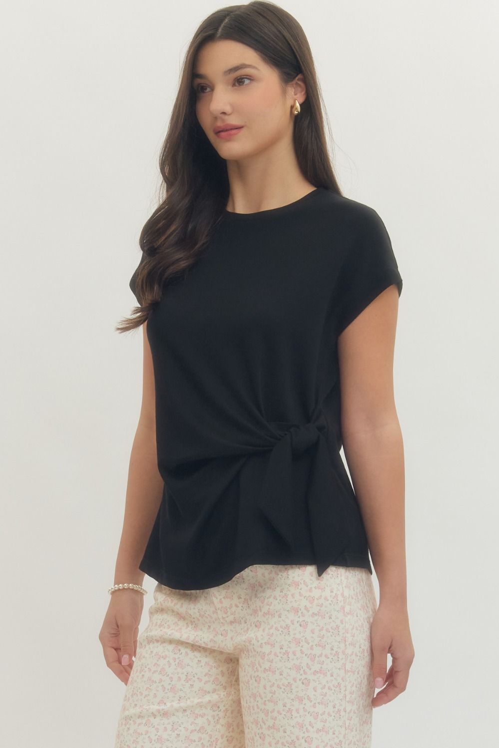 Entro Solid short-sleeve top featuring side self-tie bow detail at waist and round neck. Unlined. Knit. Non-sheer. Lightweight.