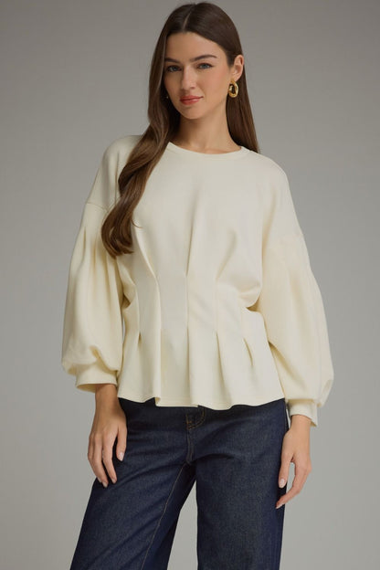 Entro-Solid long balloon sleeve top with a round neckline and pleated detail at waist.