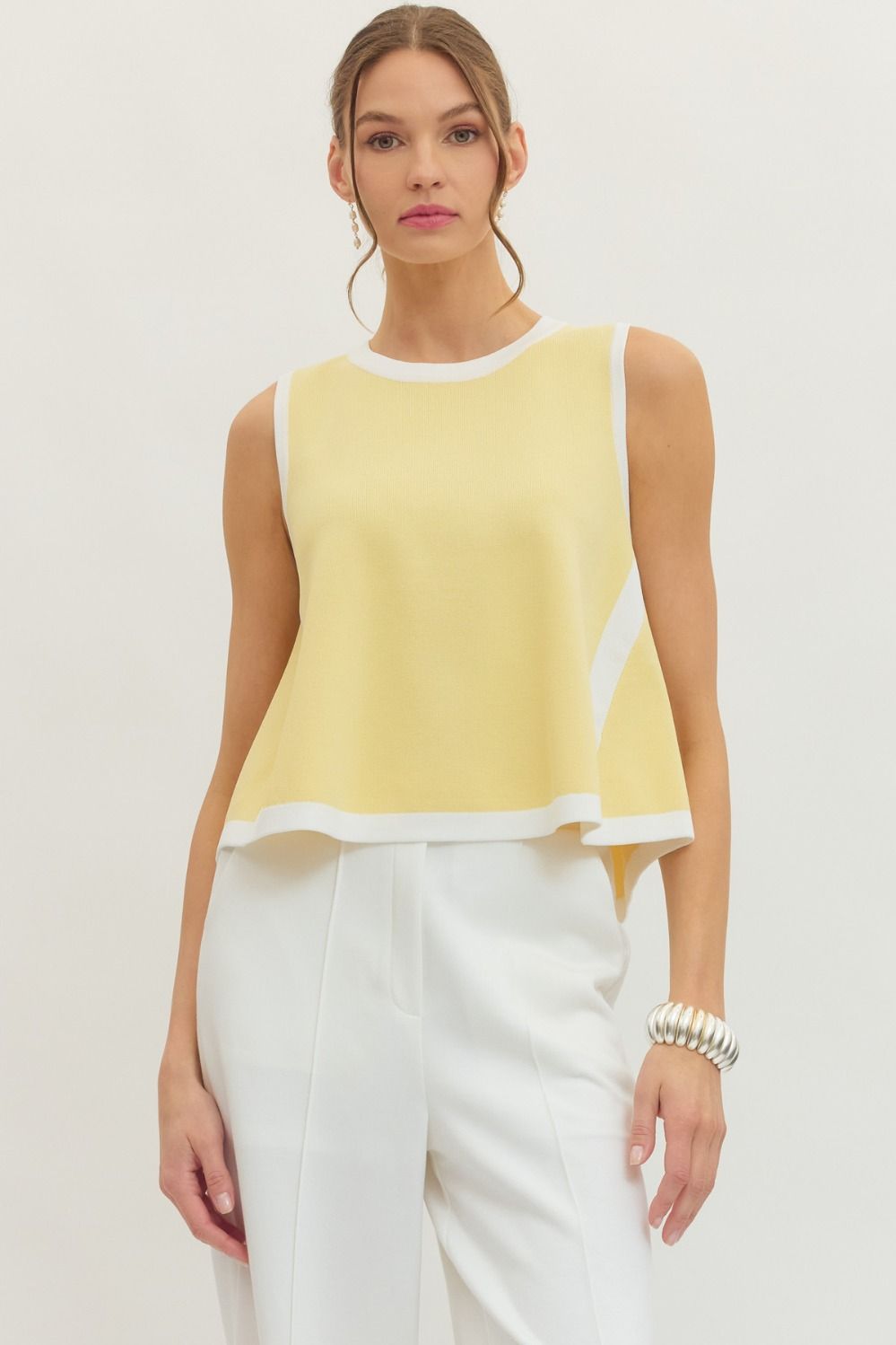 Entro Solid sleeveless knit top featuring contrast binding trim at neckline, armholes, and hem. Unlined. Knit. Non-sheer. Lightweight.