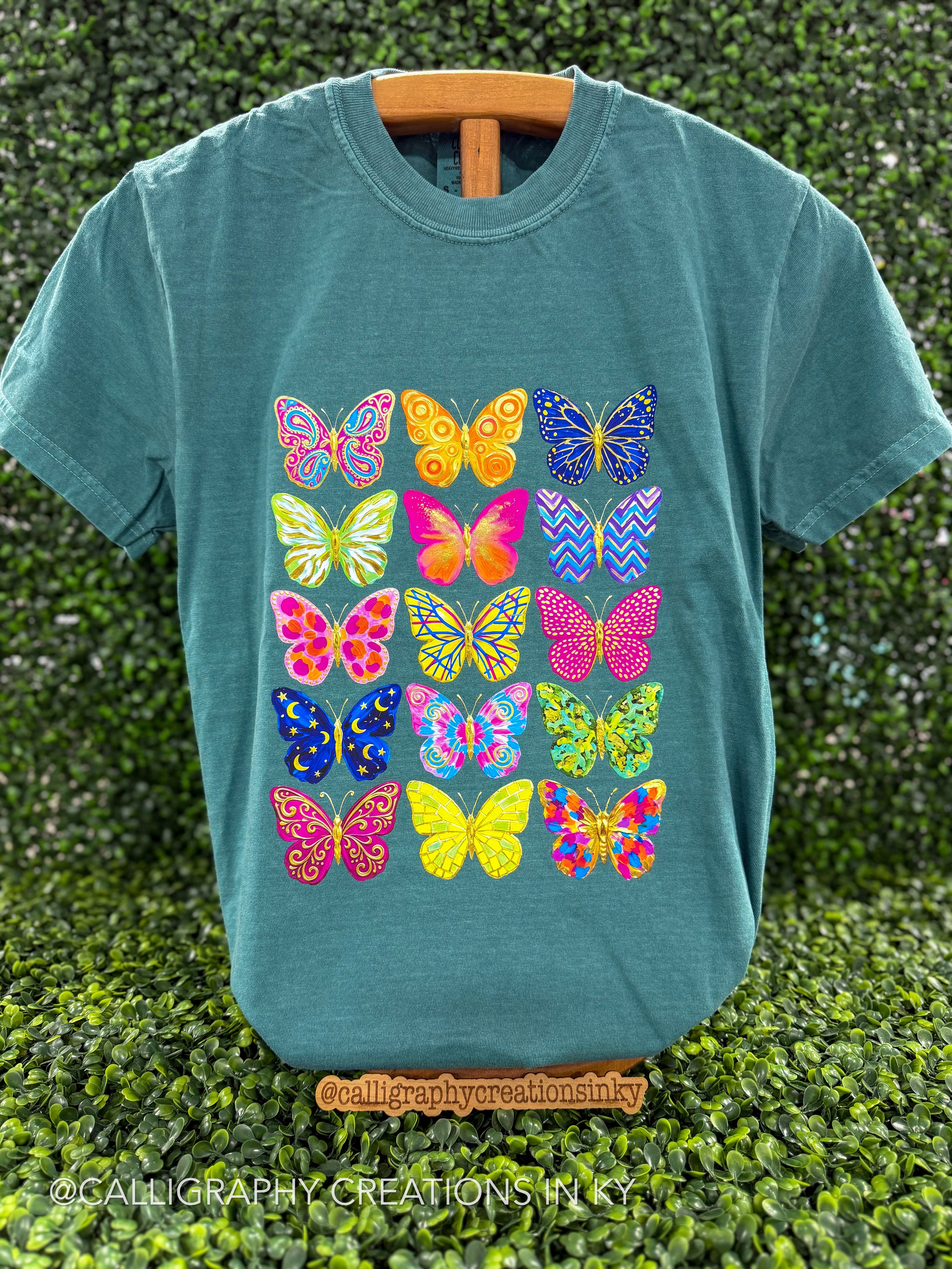 Emerald green tee with a colorful buttery design