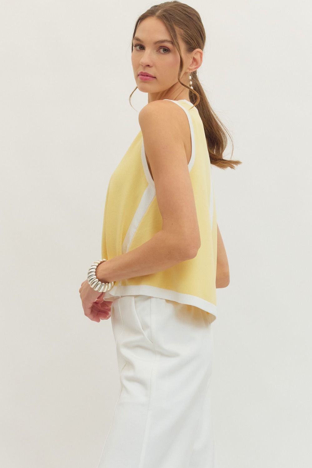 Entro Solid sleeveless knit top featuring contrast binding trim at neckline, armholes, and hem. Unlined. Knit. Non-sheer. Lightweight.