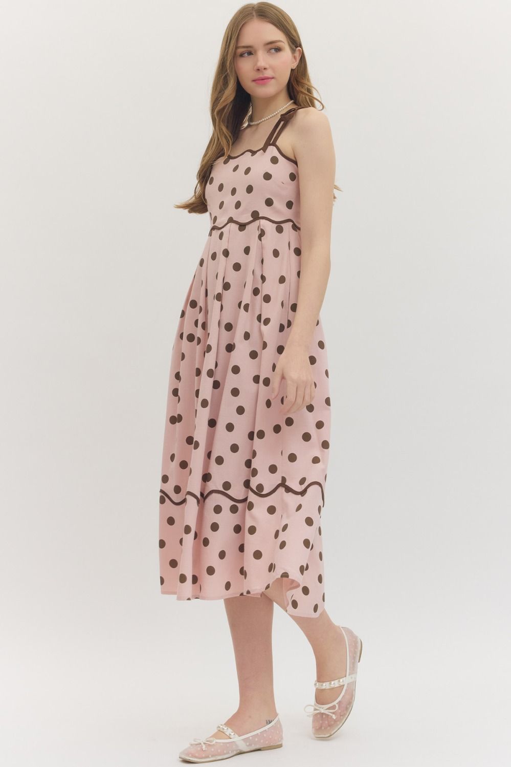 Entro Polka dot sleeveless midi dress featuring scallop accent trim at neckline. Adjustable shoulder straps. Smocked panel at back. Side pockets. Lined. Woven. Non-sheer. Lightweight.
