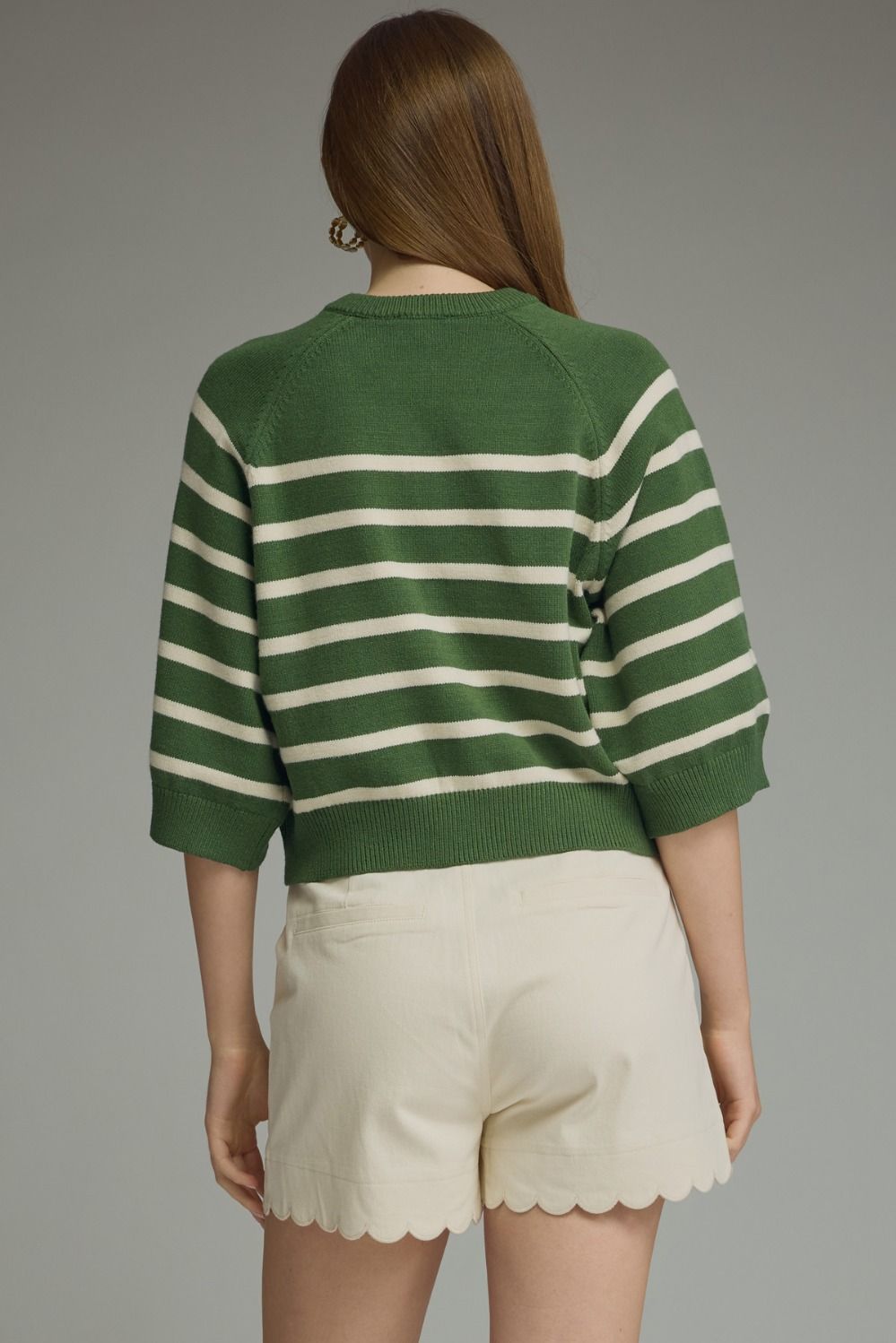 Entro-Stripe ¾ sleeve knit top featuring button closure at front. Ribbed neck band, sleeve cuffs, and hem. Unlined. Knit. Non-sheer. Lightweight.