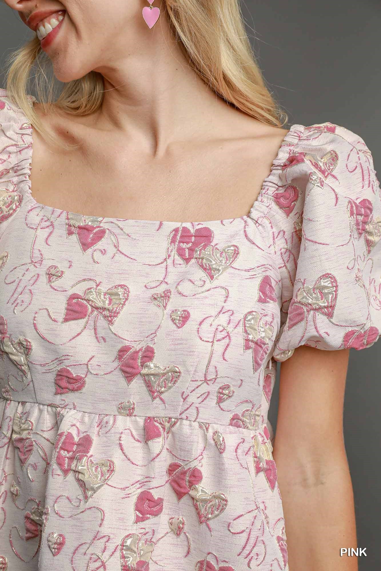 Close-up of heart jacquard fabric and bubble sleeve detail