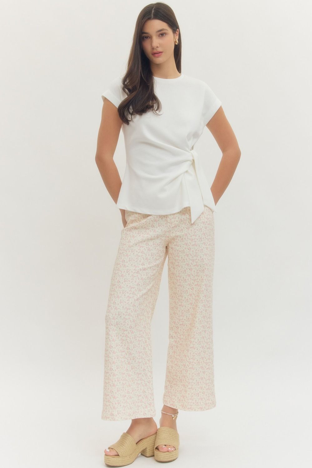 Entro Solid short-sleeve top featuring side self-tie bow detail at waist and round neck. Unlined. Knit. Non-sheer. Lightweight.