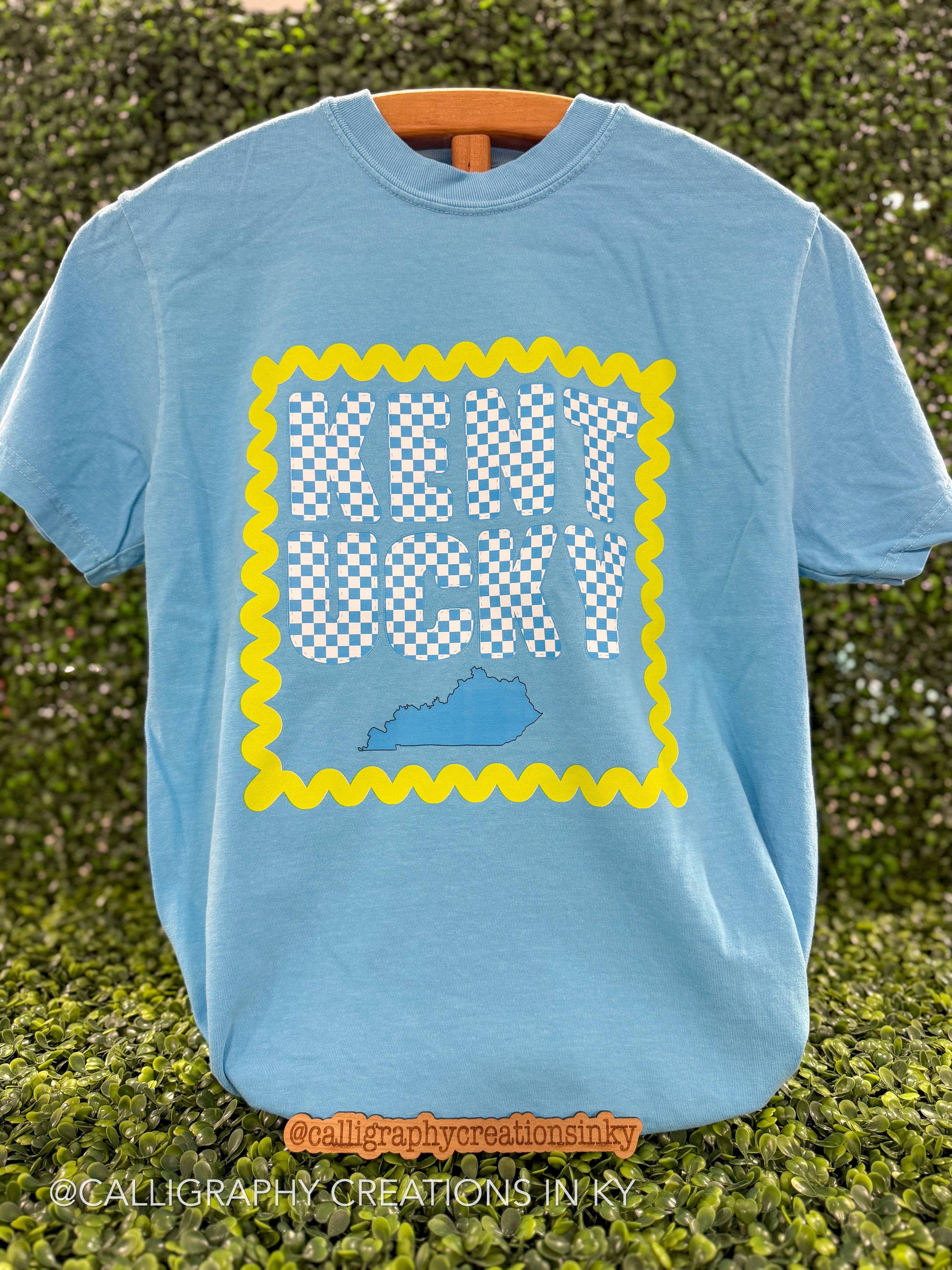 Blue colored tee with a checkered Kentucky design