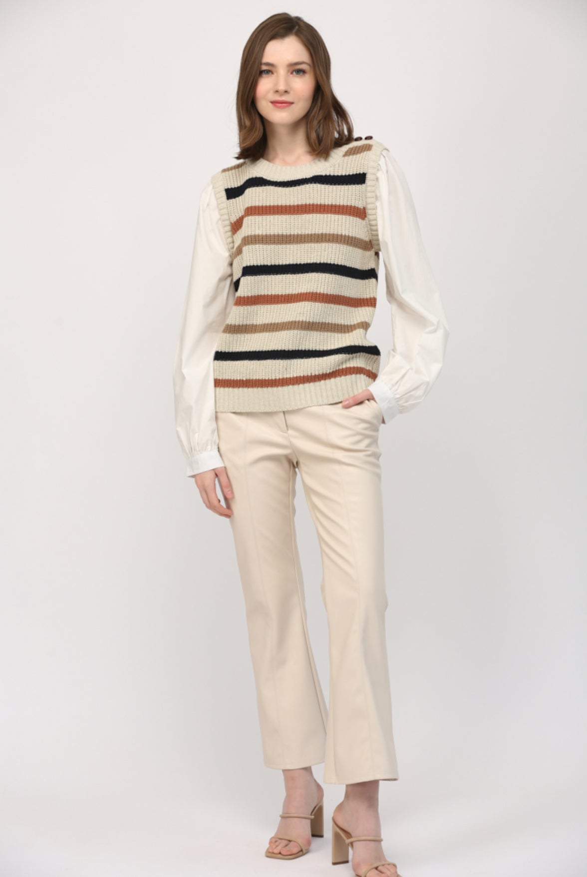 Model wearing women’s striped sweater vest with poplin undershirt, casual chic
