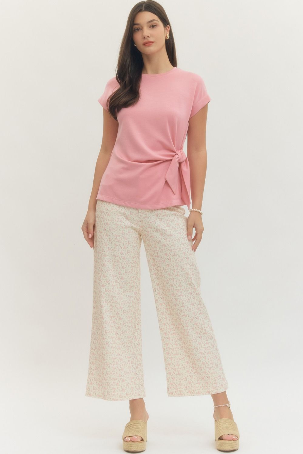 Entro Solid short-sleeve top featuring side self-tie bow detail at waist and round neck. Unlined. Knit. Non-sheer. Lightweight.
