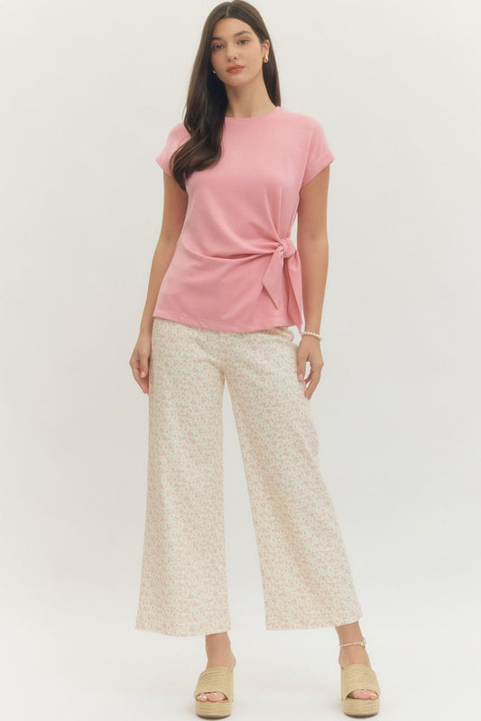 Entro Solid short-sleeve top featuring side self-tie bow detail at waist and round neck. Unlined. Knit. Non-sheer. Lightweight.