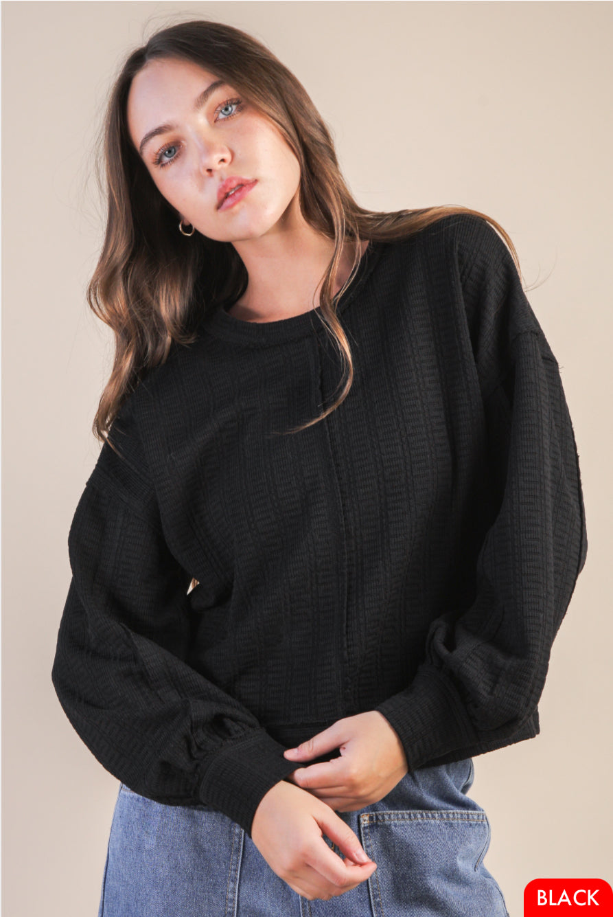Cozy long sleeve knit top with dropped shoulder and round neckline