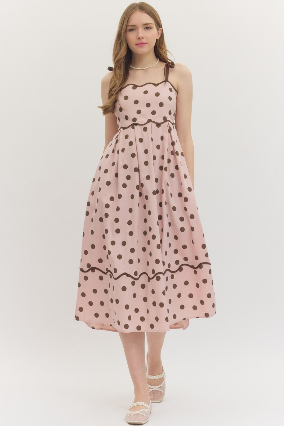 Entro Polka dot sleeveless midi dress featuring scallop accent trim at neckline. Adjustable shoulder straps. Smocked panel at back. Side pockets. Lined. Woven. Non-sheer. Lightweight.