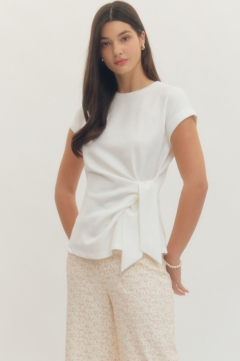 Entro Solid short-sleeve top featuring side self-tie bow detail at waist and round neck. Unlined. Knit. Non-sheer. Lightweight.