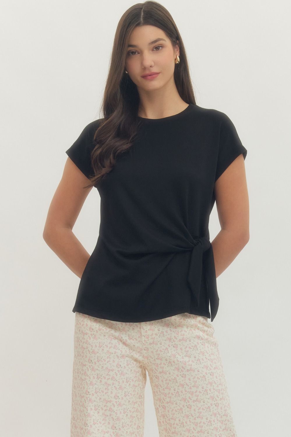 Entro Solid short-sleeve top featuring side self-tie bow detail at waist and round neck. Unlined. Knit. Non-sheer. Lightweight.