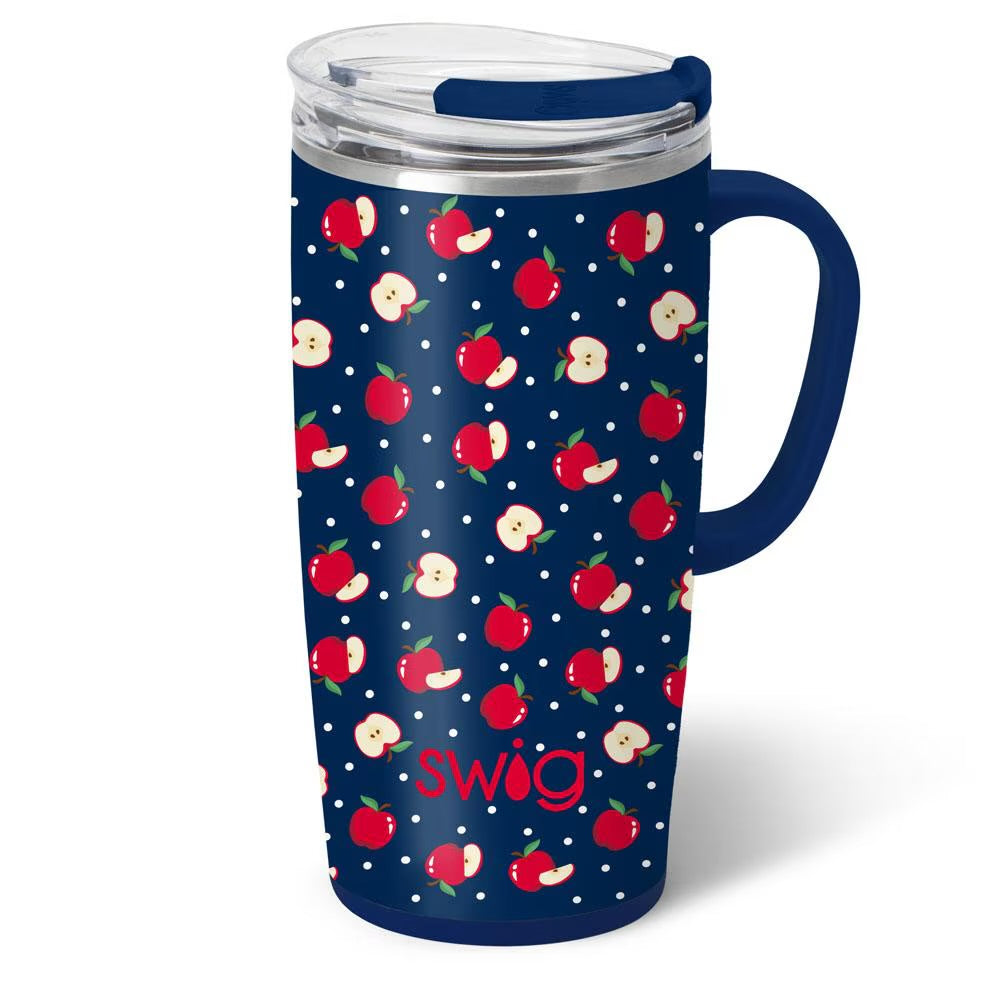 A navy blue insulated travel tumbler with a clear lid and navy handle, decorated with a repeating pattern of red apples and white dots, featuring the text 'swig' in red near the bottom.