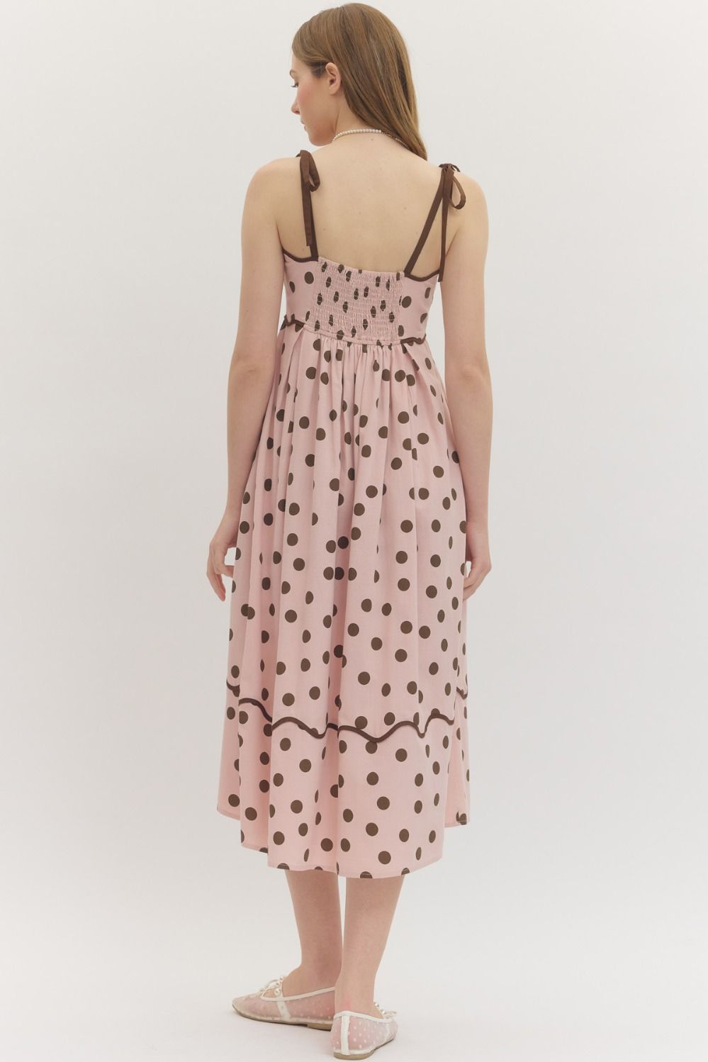 Entro Polka dot sleeveless midi dress featuring scallop accent trim at neckline. Adjustable shoulder straps. Smocked panel at back. Side pockets. Lined. Woven. Non-sheer. Lightweight.