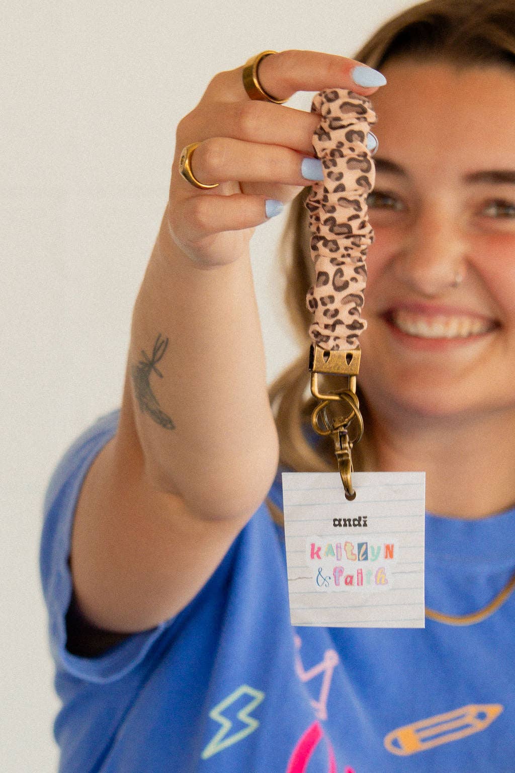 Person holding a leopard print keychain