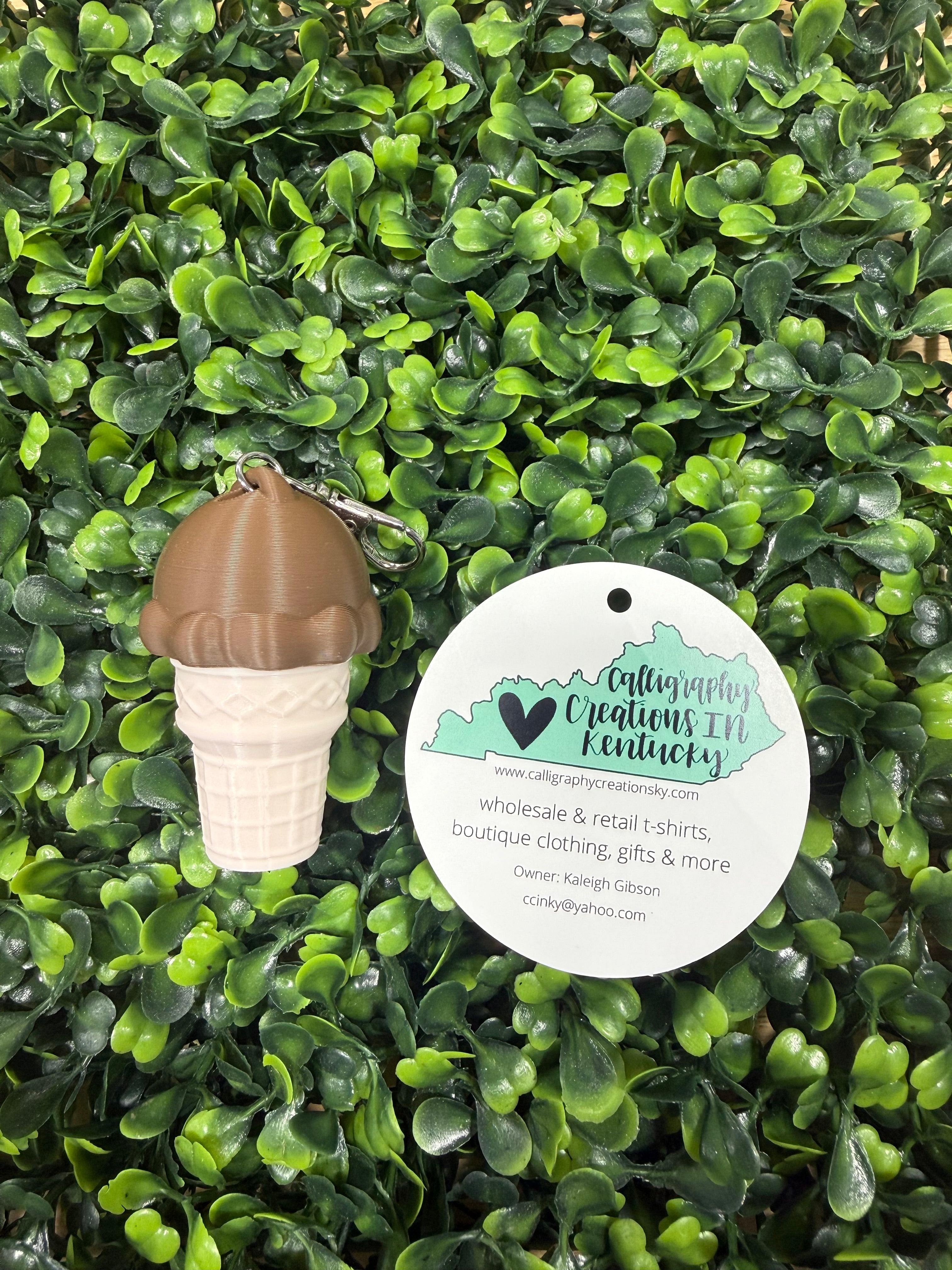 Chocolate ice cream key chain on a green leafy background