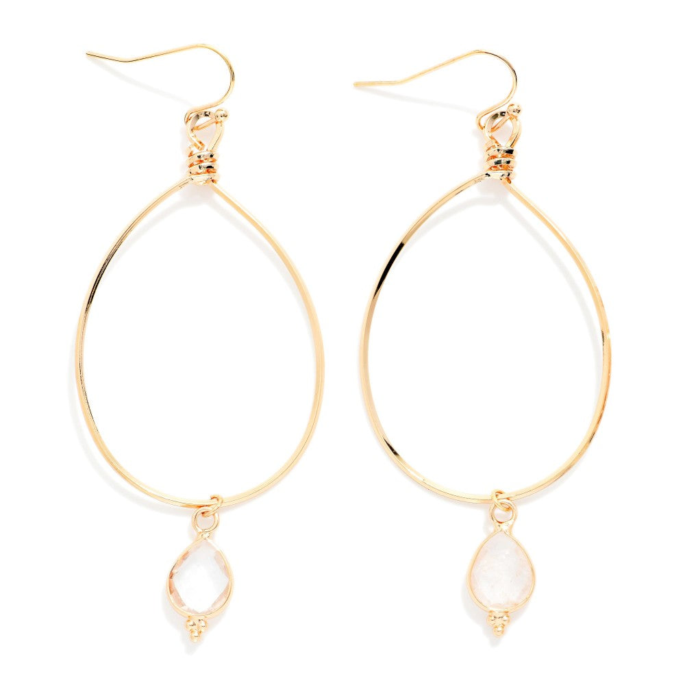 Gold wire teardrop earrings with clear dangle gem charm on a white background 