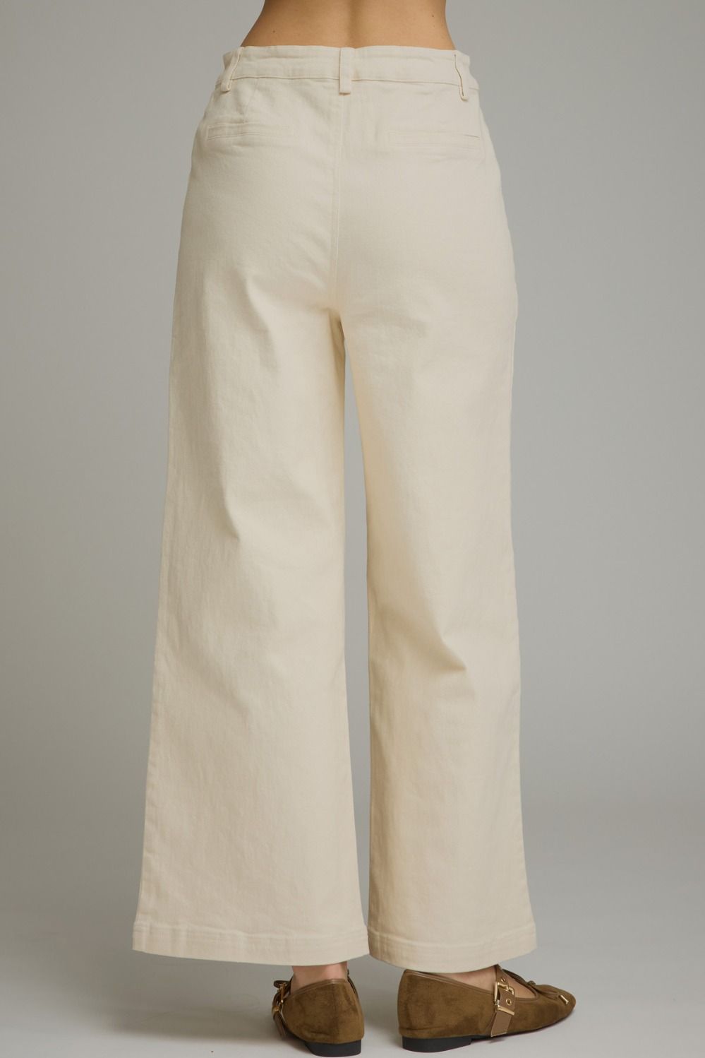 Entro-Solid wide leg pants featuring a zip-fly button front closure. Front patch pockets with hardware accent. Decorative back welt pockets. Belt loops.