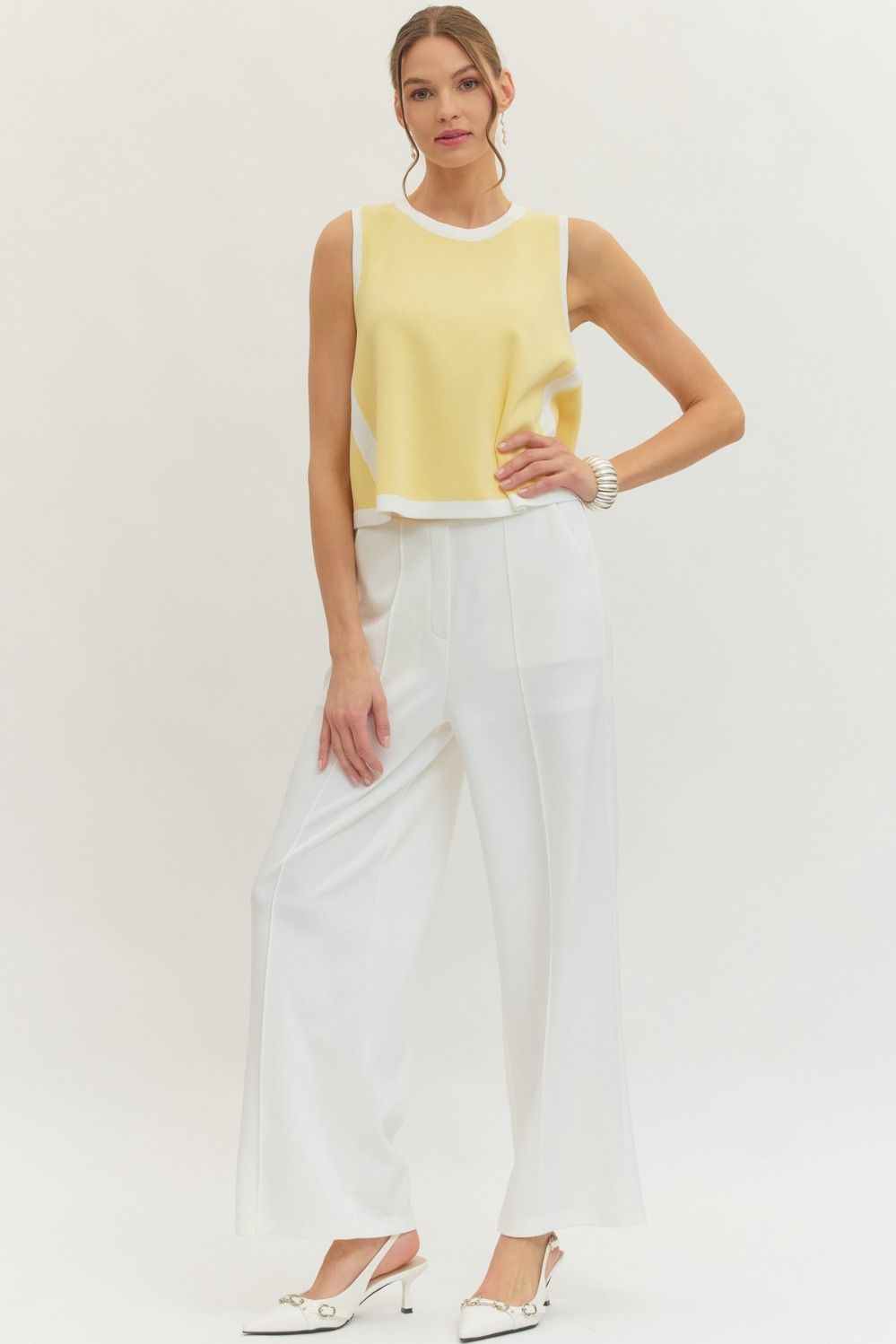 Entro Solid sleeveless knit top featuring contrast binding trim at neckline, armholes, and hem. Unlined. Knit. Non-sheer. Lightweight.