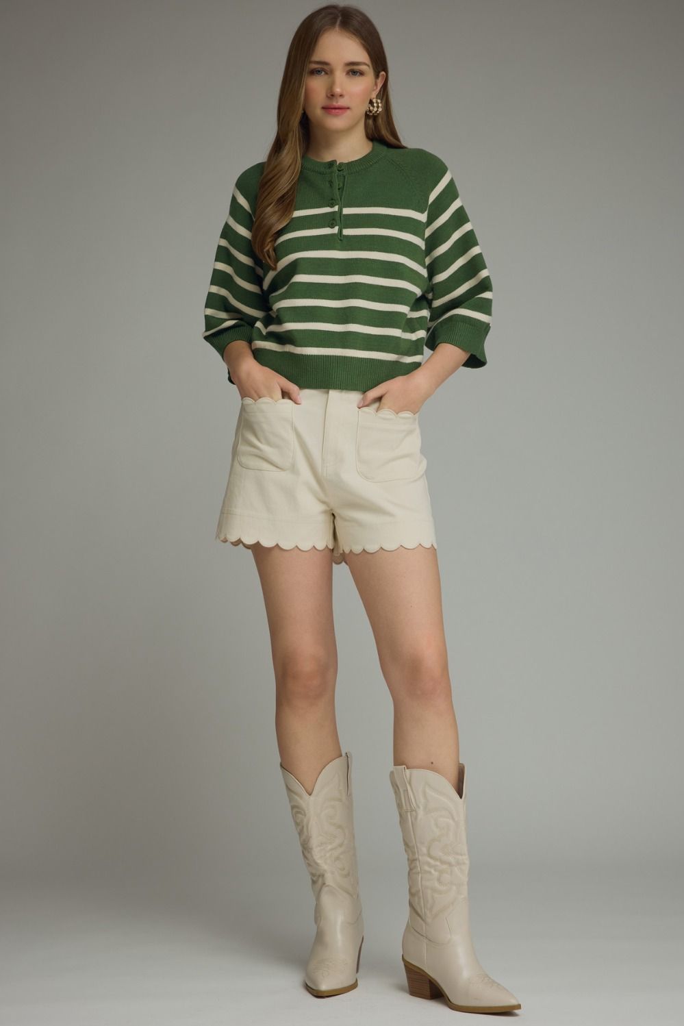 Entro-Stripe ¾ sleeve knit top featuring button closure at front. Ribbed neck band, sleeve cuffs, and hem. Unlined. Knit. Non-sheer. Lightweight.