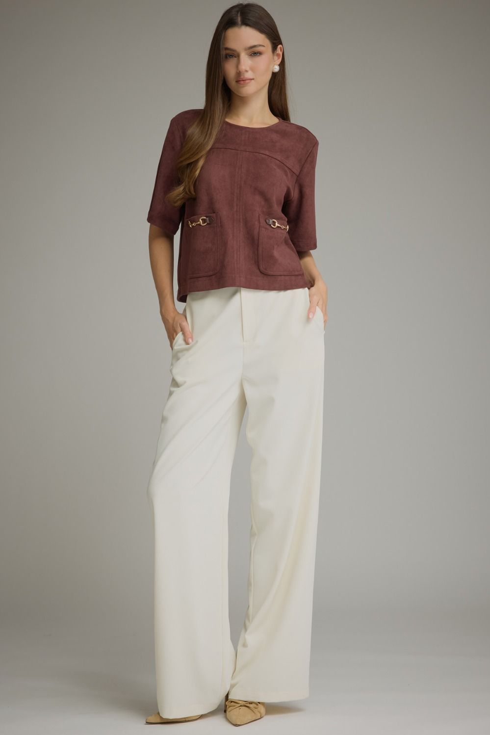 Entro-Solid short sleeve top with a boat neckline and front patch pockets. Metal hardware detail at pockets.