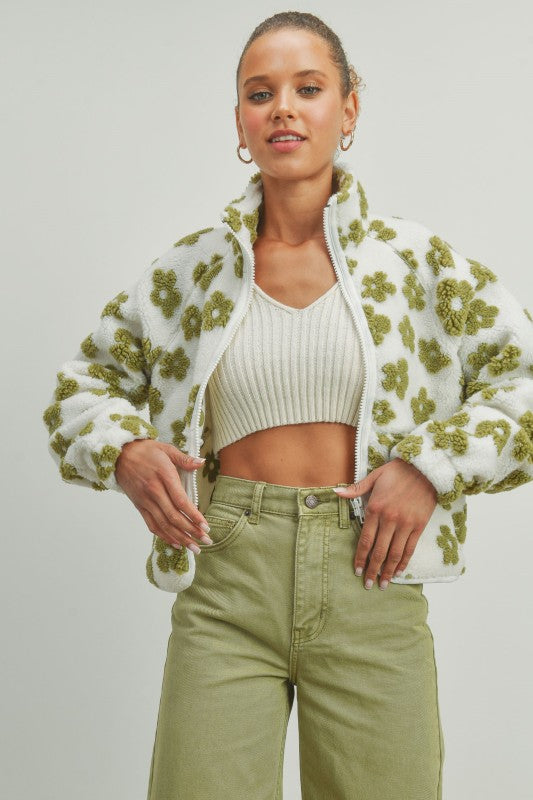 Model wearing daisy flower pattern fleece sherpa jacket in green and white