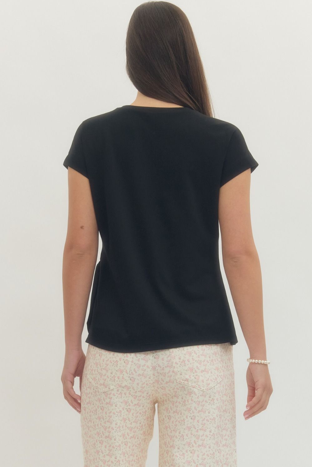 Entro Solid short-sleeve top featuring side self-tie bow detail at waist and round neck. Unlined. Knit. Non-sheer. Lightweight.