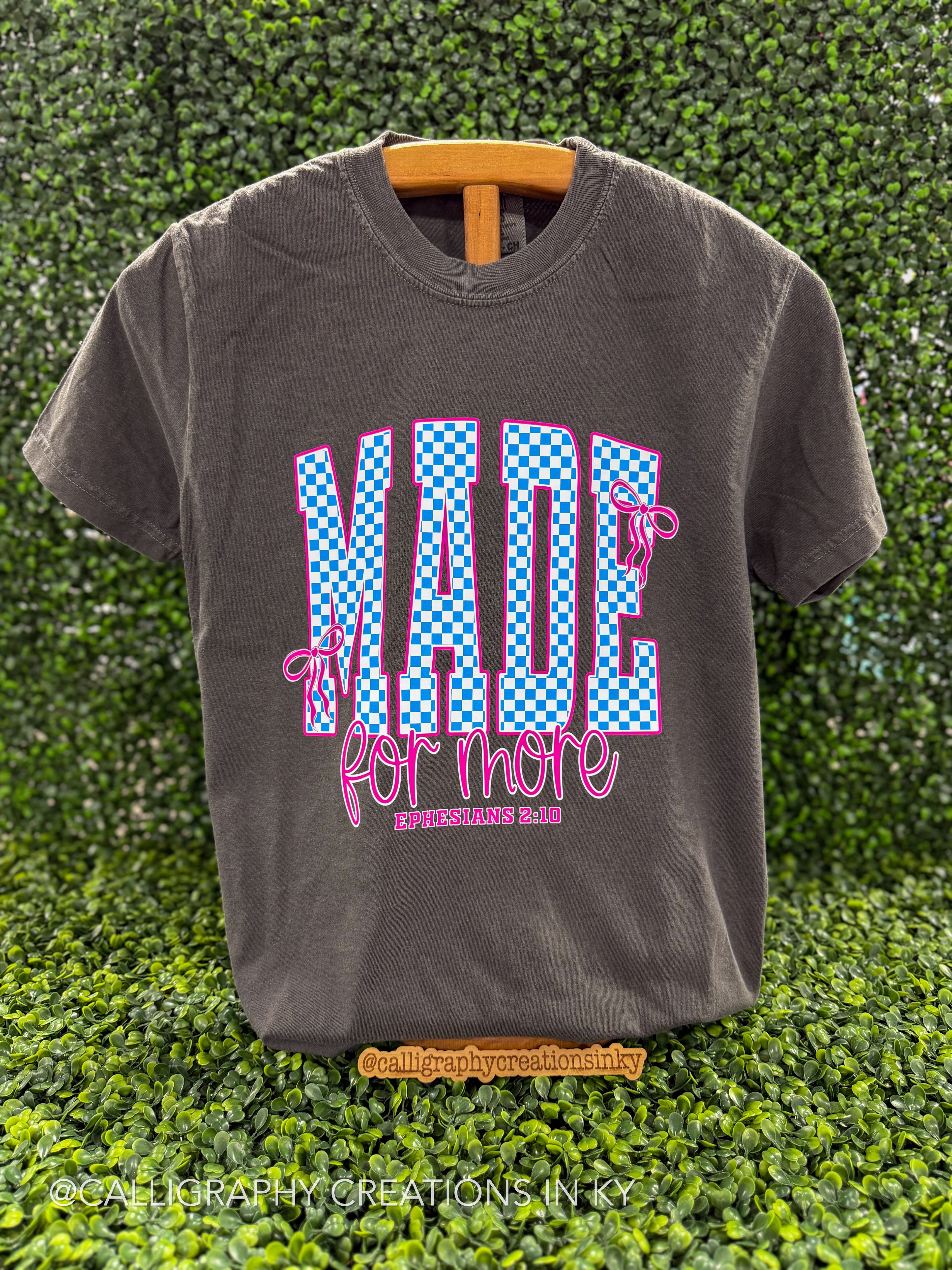 Gray tee that says “Made For More”