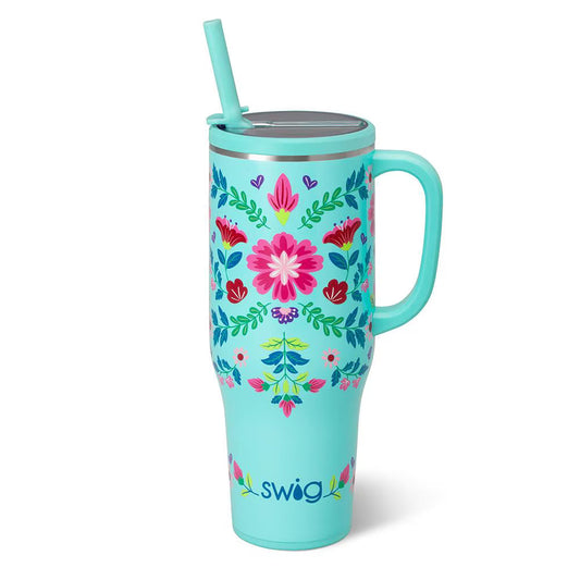 Turquoise tumbler with floral design and straw on a white background