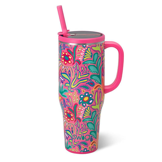 Colorful tumbler with floral pattern and pink handle on a white background