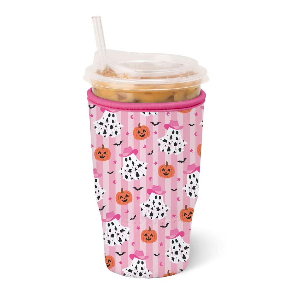 A pink insulated travel coolie with a Halloween-themed pattern of pumpkins, ghostly faces, bats, and bows, shown with a clear lid and straw on a white background.