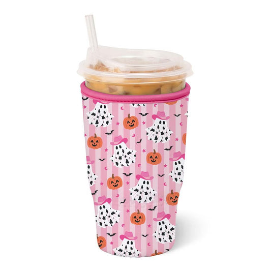 A pink insulated travel coolie with a Halloween-themed pattern of pumpkins, ghostly faces, bats, and bows, shown with a clear lid and straw on a white background.