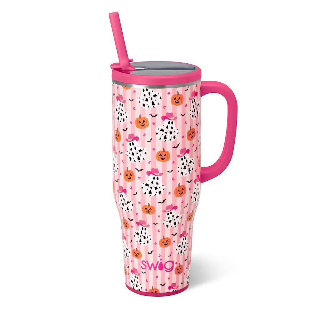 A pink insulated travel tumbler with a Halloween-themed pattern of pumpkins and ghosts with cowprint featuring a pink handle, lid, and straw.