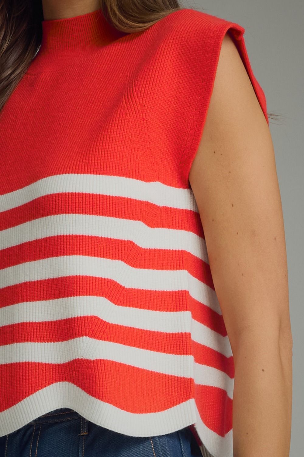 Entro-Stripe mock neck sleeveless sweater knit top featuring scallop hem.