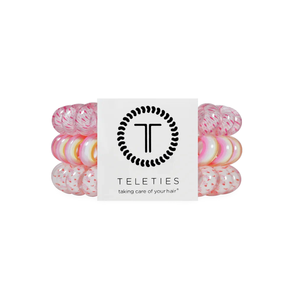 Pack of pink hair ties with a brand label on a white background
