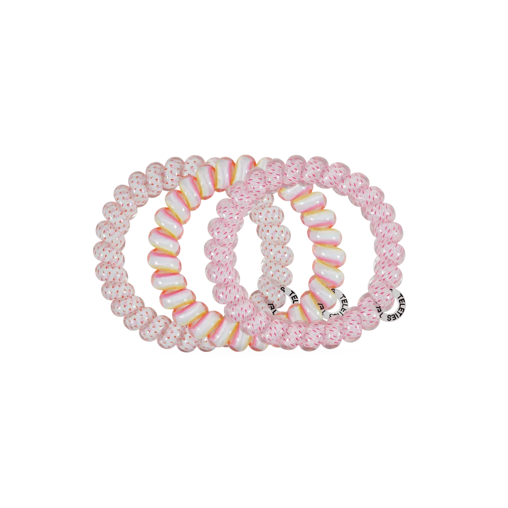 Three pink beaded stretch hair ties arranged overlapping on a plain white background.