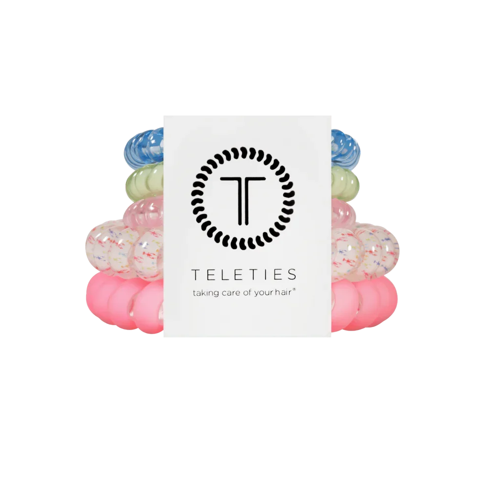 Colorful hair ties stacked with a Teleties branded card on a white background