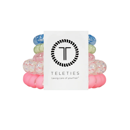 Colorful hair ties stacked with a Teleties branded card on a white background