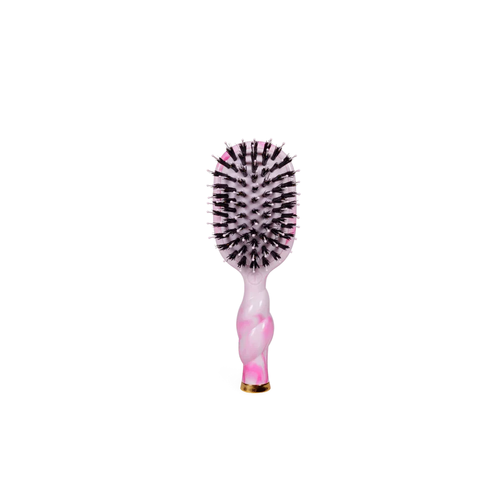 Pink and black hairbrush on a white background