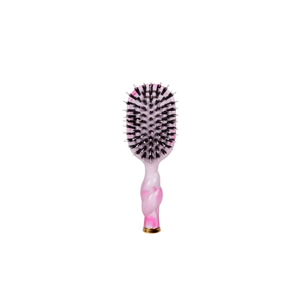 Pink and black hairbrush on a white background