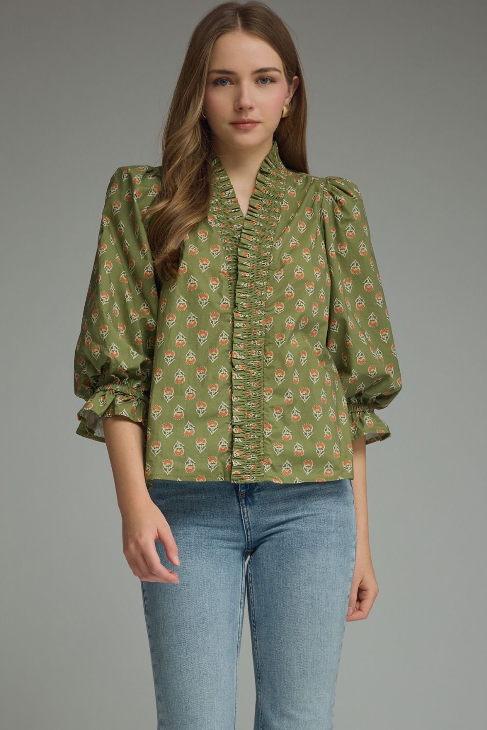 Entro-Print ¾ puff sleeve top featuring smocked V-neck detail. Ruffle detail at sleeve hem. Unlined. Woven. Non-sheer. Lightweight.